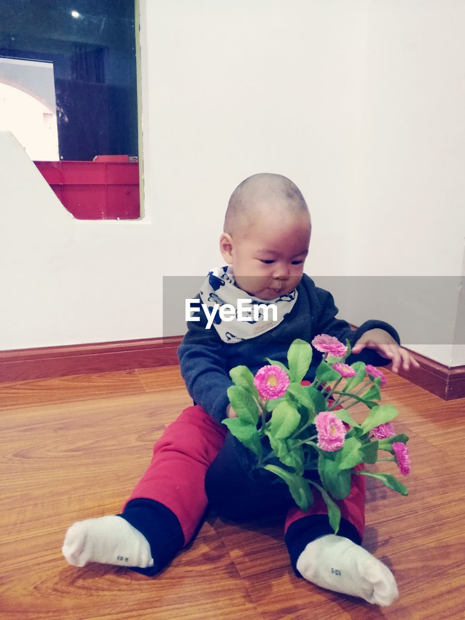 Cute boy with bouquet at home