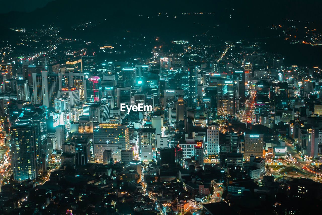 High angle view of illuminated city buildings at night