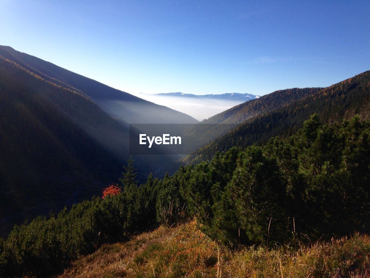 Scenic view of mountains against clear blue sky