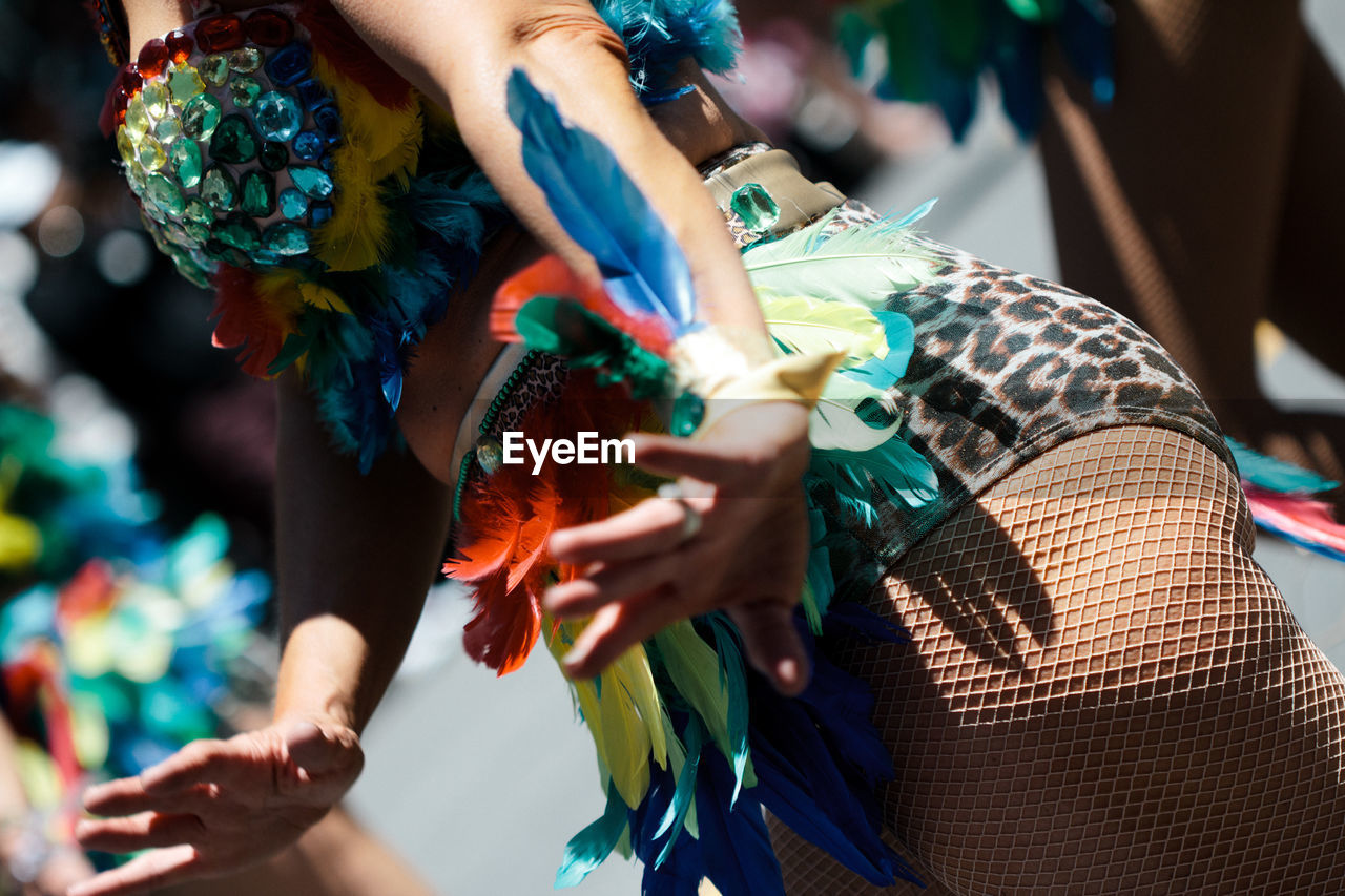 CROPPED IMAGE OF WOMAN STANDING ON WHITE SURFACE
