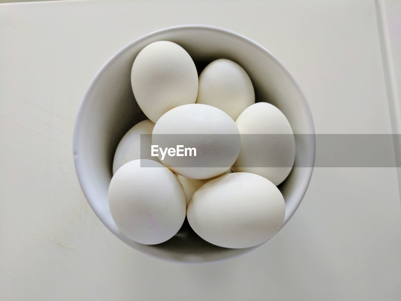 HIGH ANGLE VIEW OF EGGS IN WHITE BACKGROUND