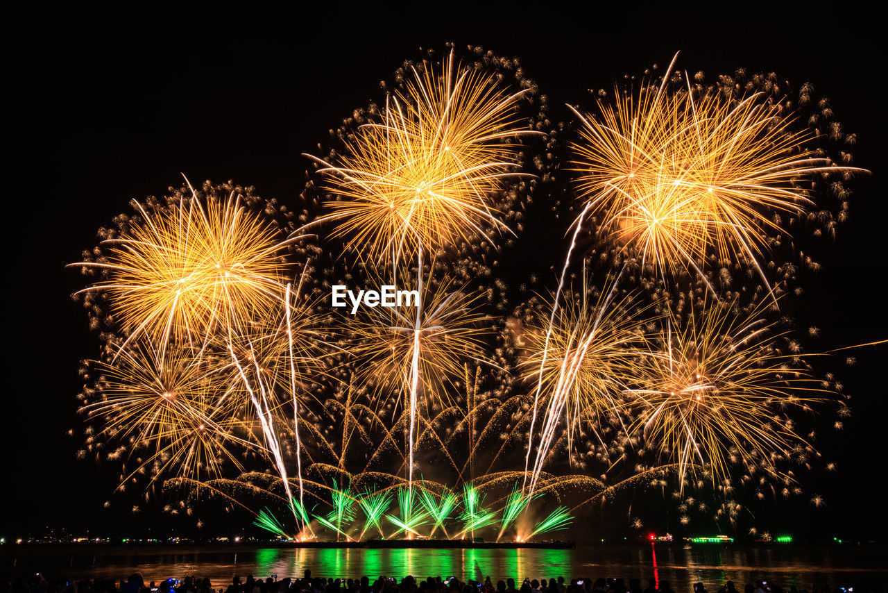 night, illuminated, fireworks, celebration, event, arts culture and entertainment, firework display, motion, exploding, new year's eve, nature, recreation, glowing, firework - man made object, sky, no people, multi colored, outdoors, water, architecture, emotion, light