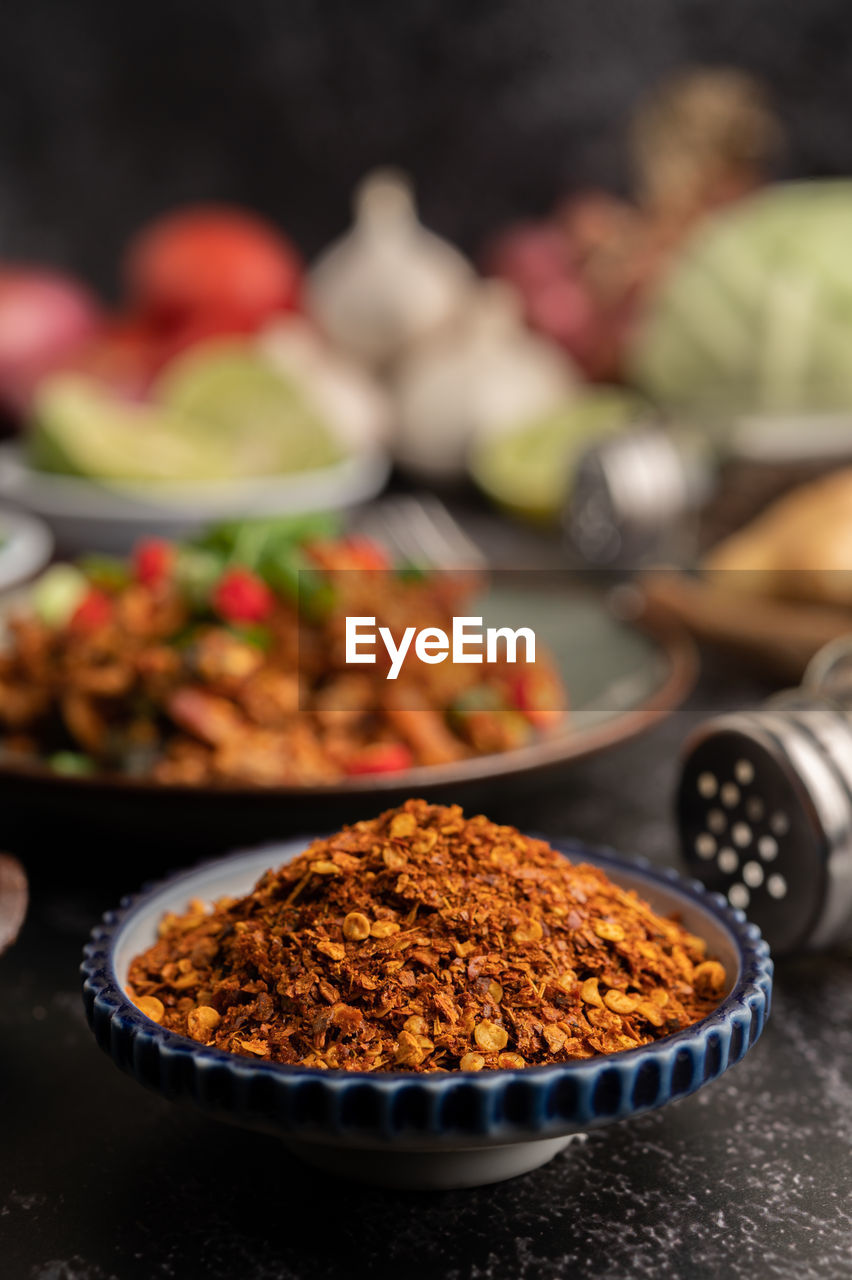 CLOSE-UP OF RED CHILI PEPPER ON TABLE