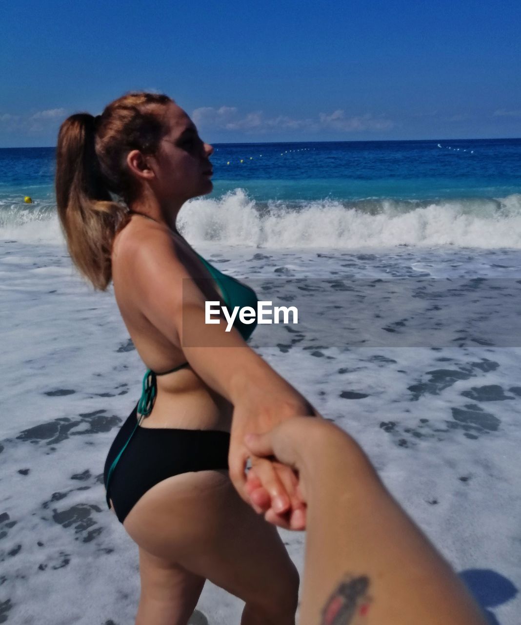 YOUNG WOMAN ON BEACH