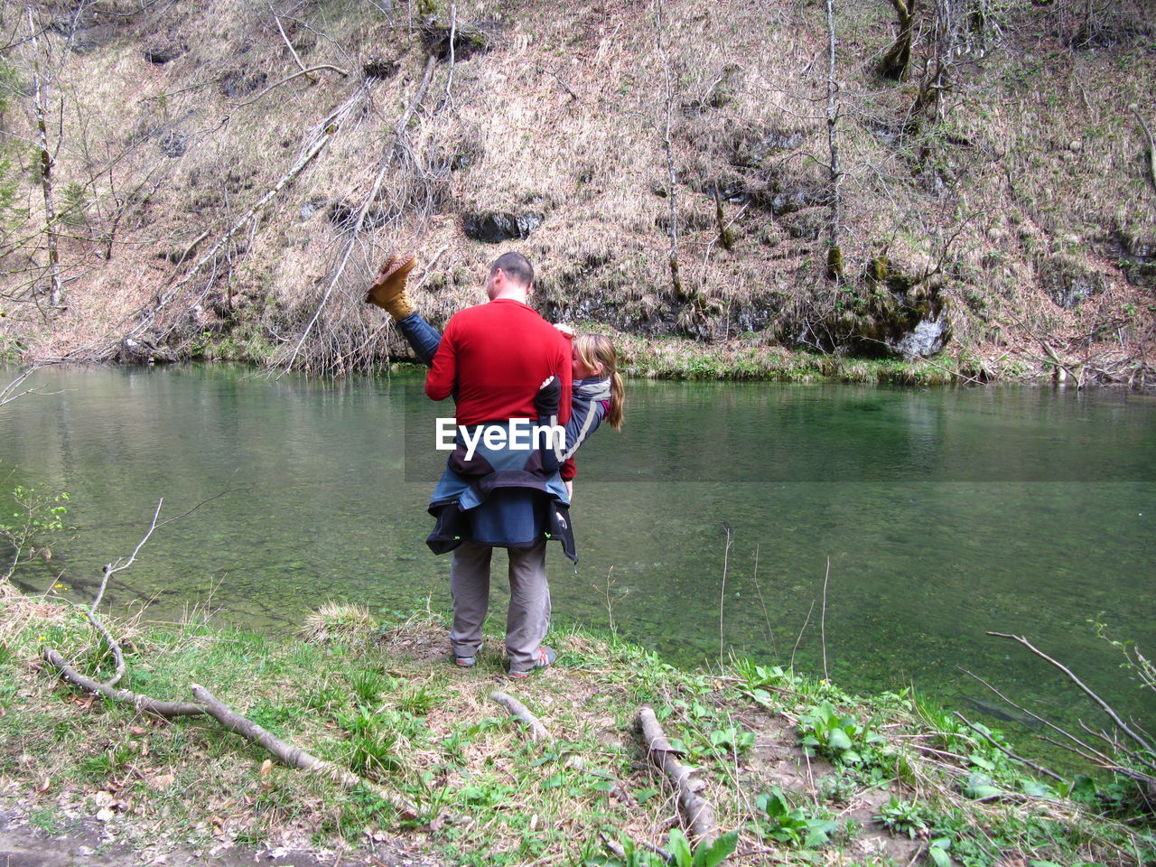 MAN STANDING IN LAKE