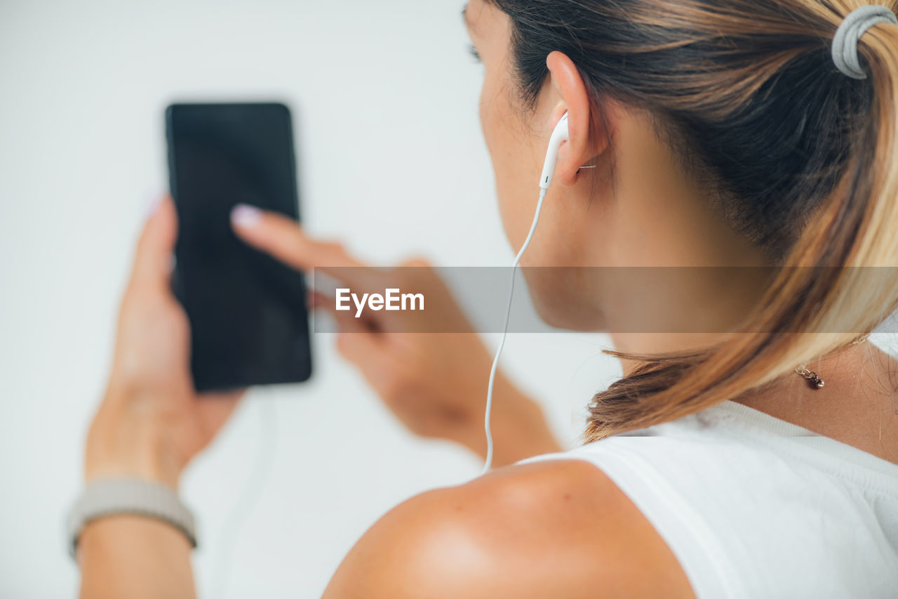 Woman with headphones self-testing hearing