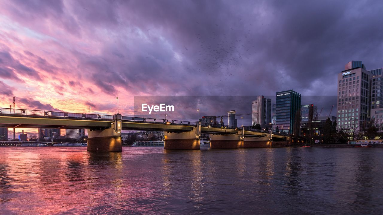 View of bridge over river against cloudy sky