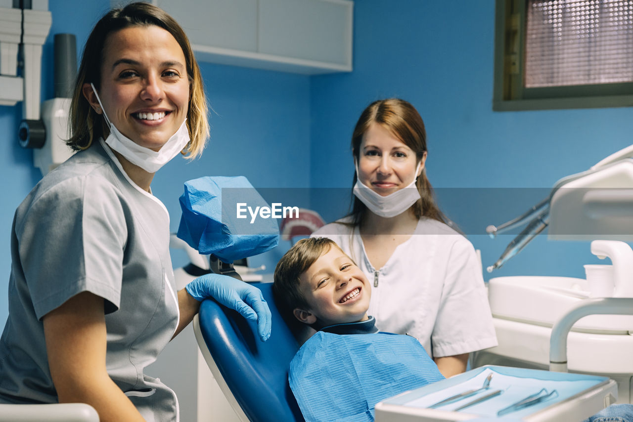 Dentists examining patient in clinic