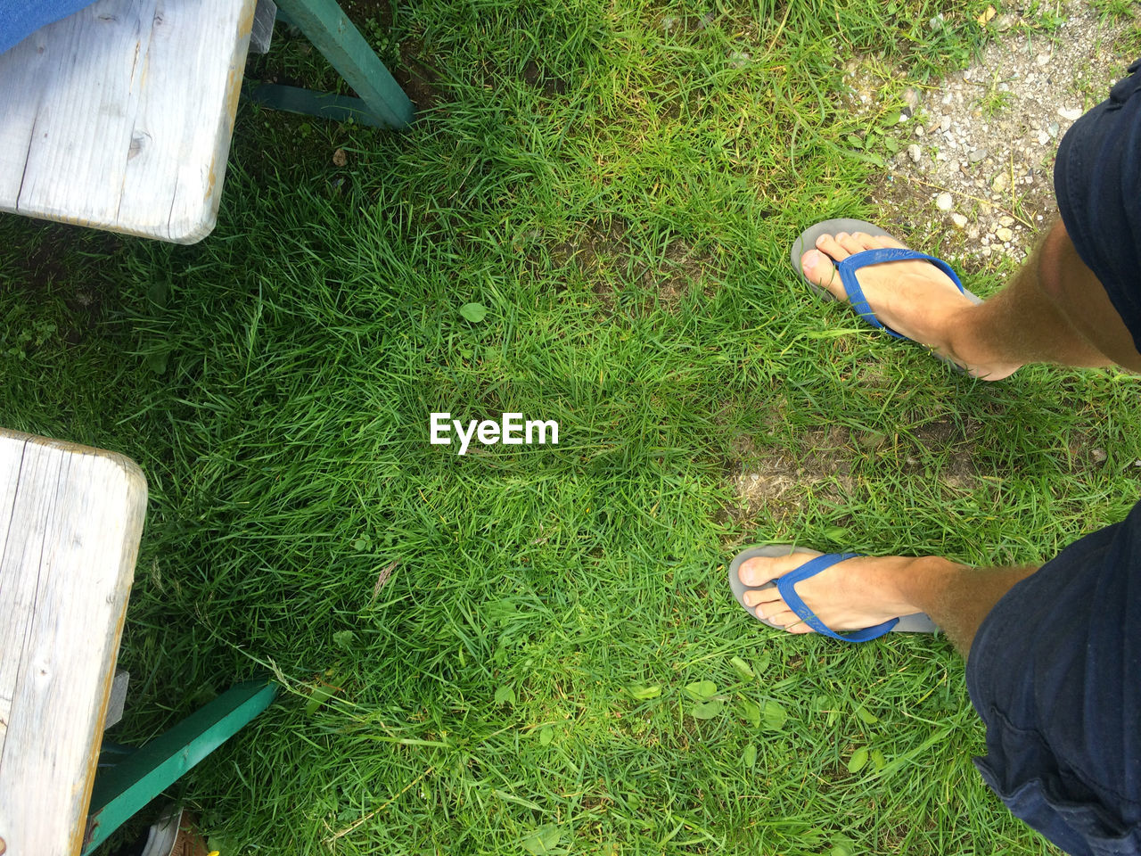 LOW SECTION OF MAN STANDING ON GRASS