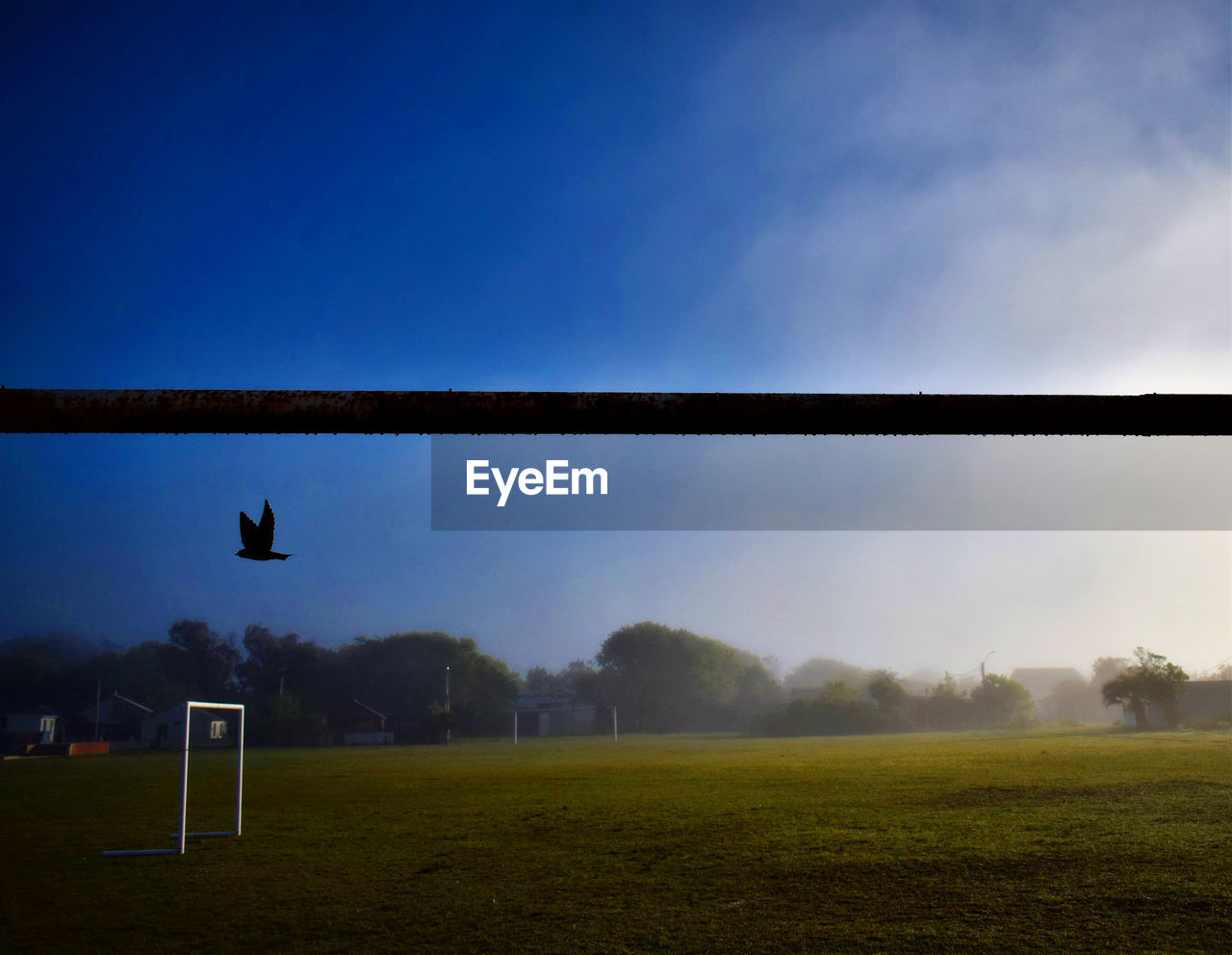 SCENIC VIEW OF SOCCER FIELD AGAINST BLUE SKY