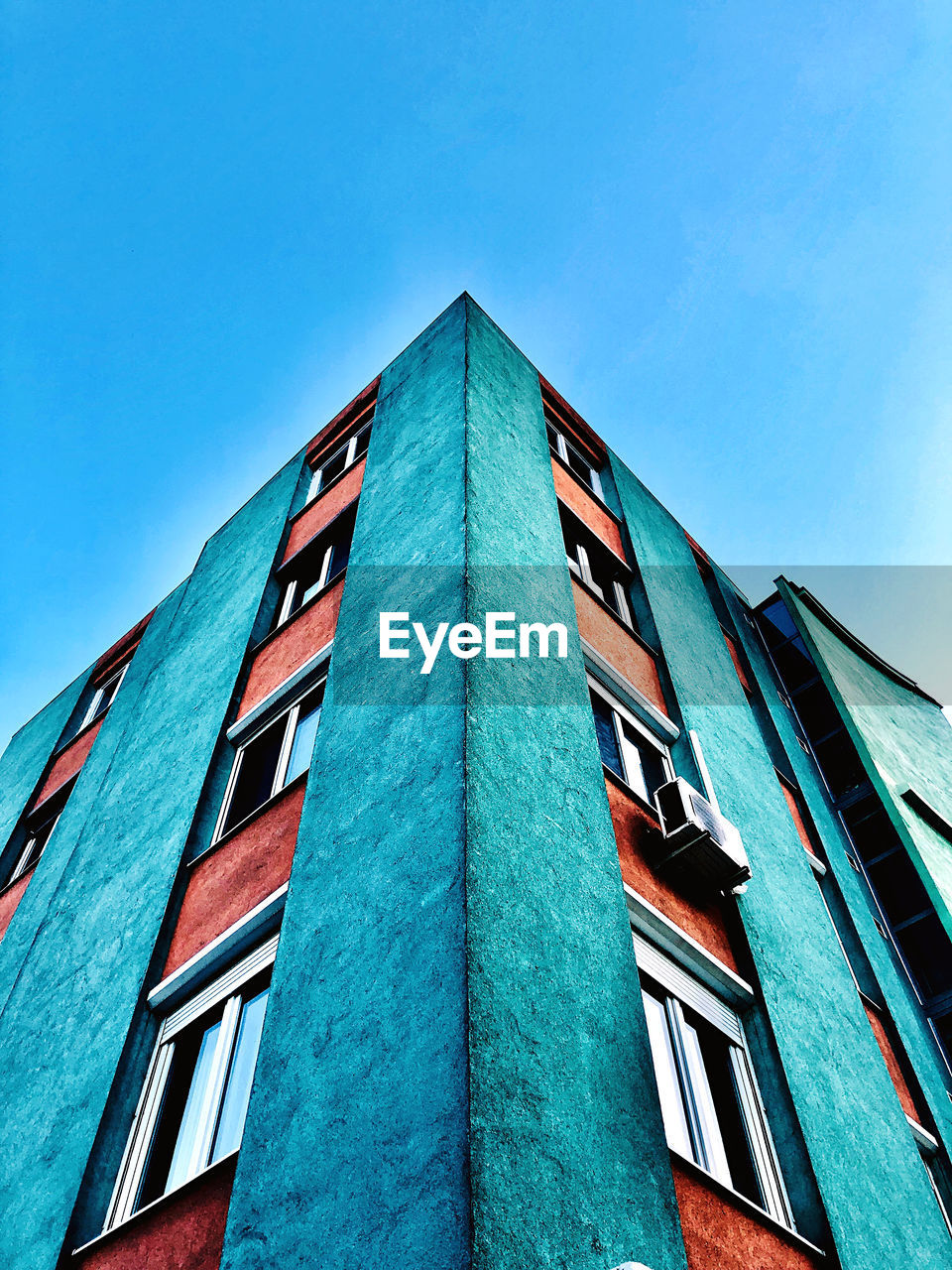 Low angle view of building against clear blue sky