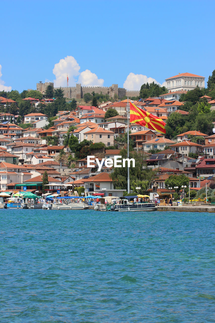 VIEW OF TOWNSCAPE BY SEA AGAINST SKY