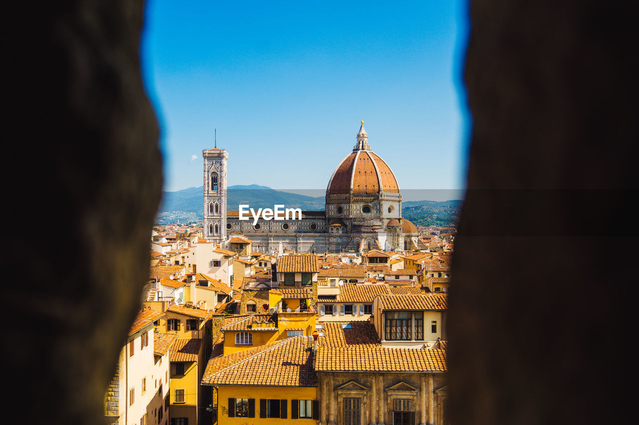 Looking through a hole in the building to santa maria del fiore.