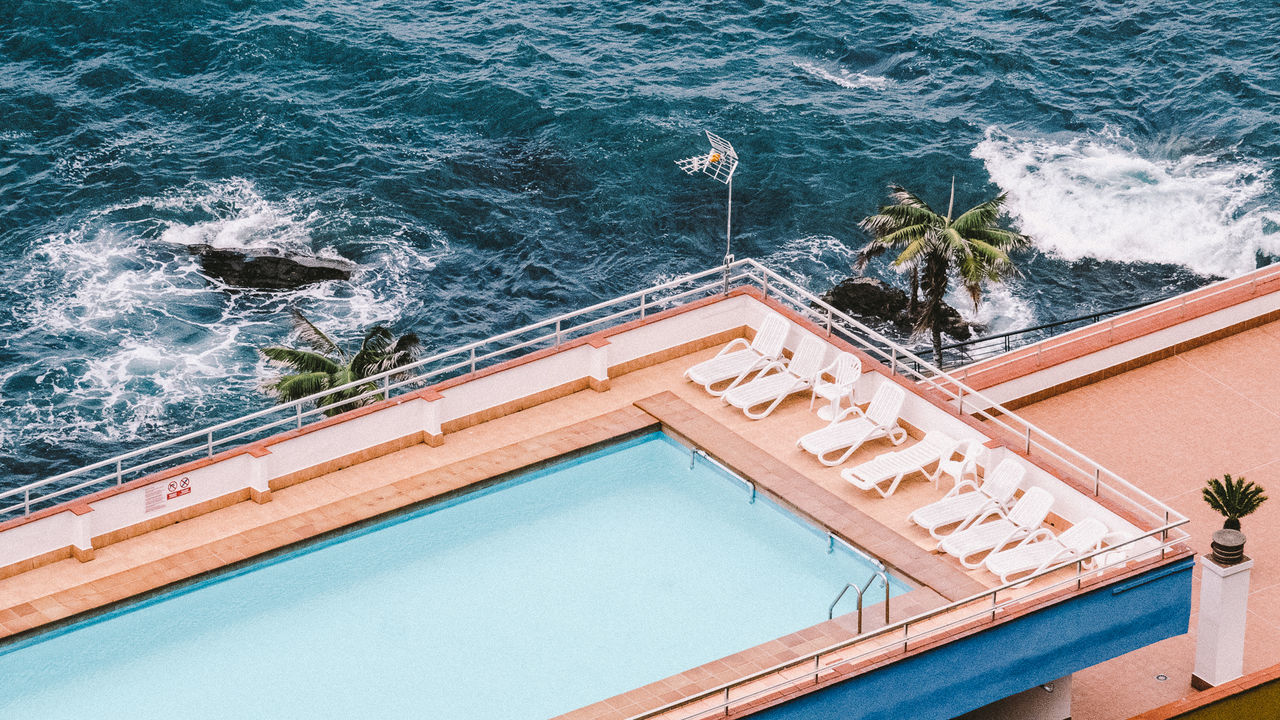 HIGH ANGLE VIEW OF SWIMMING POOL BY TREES