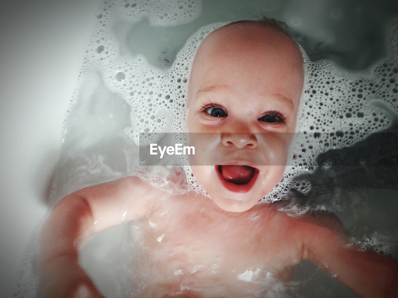 High angle portrait of baby boy in bathtub