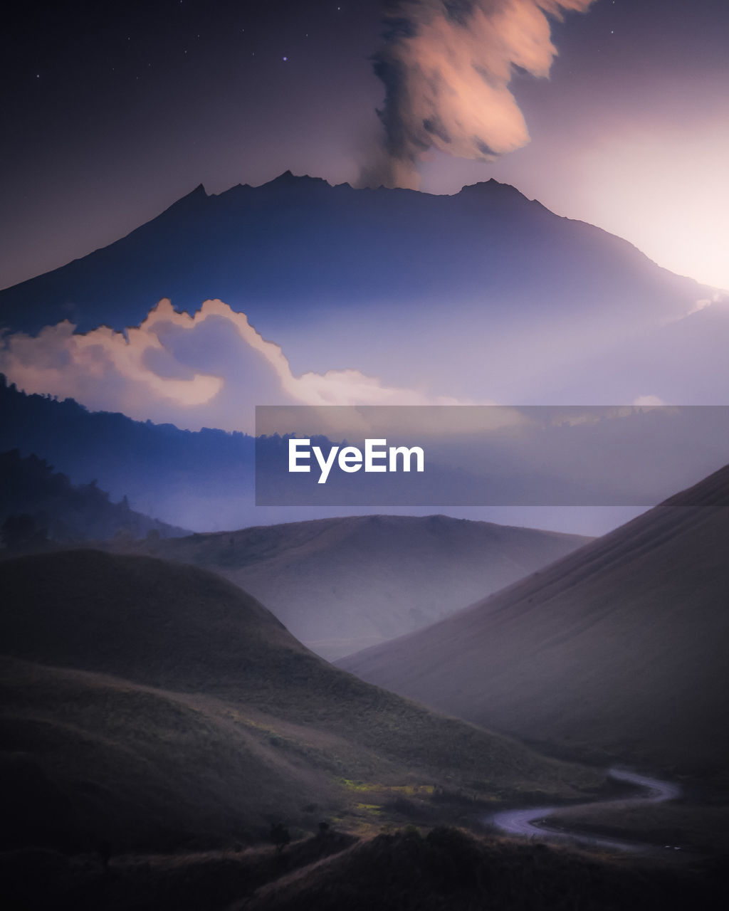 Scenic view of mountains against sky at dusk