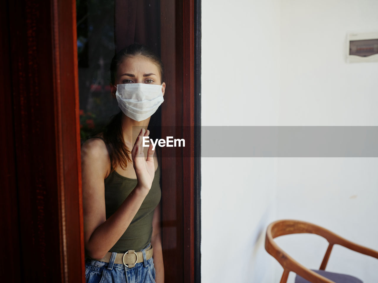 Portrait of woman standing by door