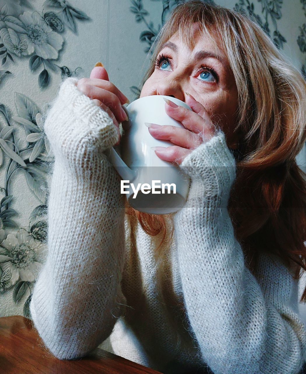 Young woman drinking coffee at home