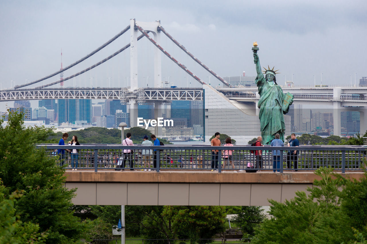 View of the rainbow bridge and statue of liberty in odaiba, japan