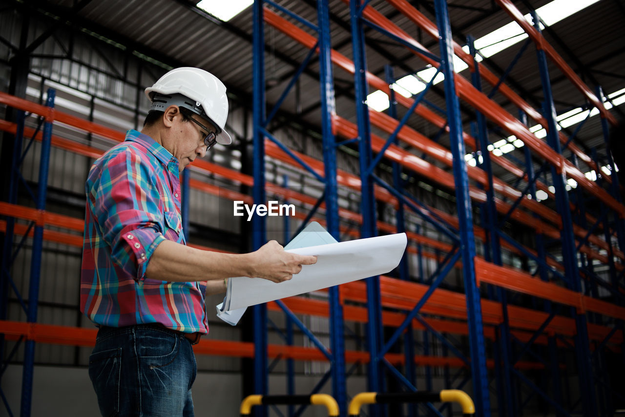 Man working while standing in warehouse