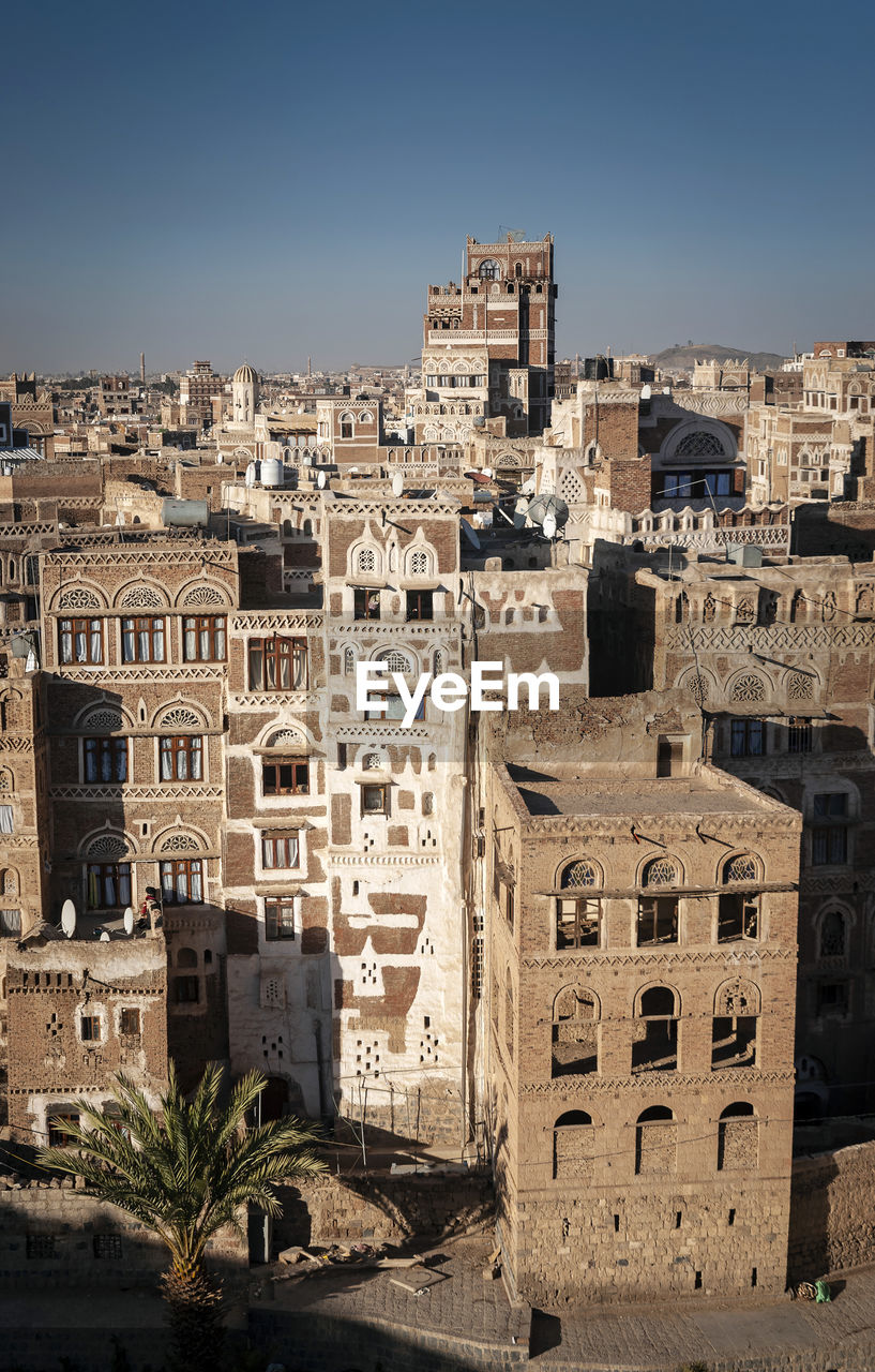 High angle view of old buildings against clear sky in city