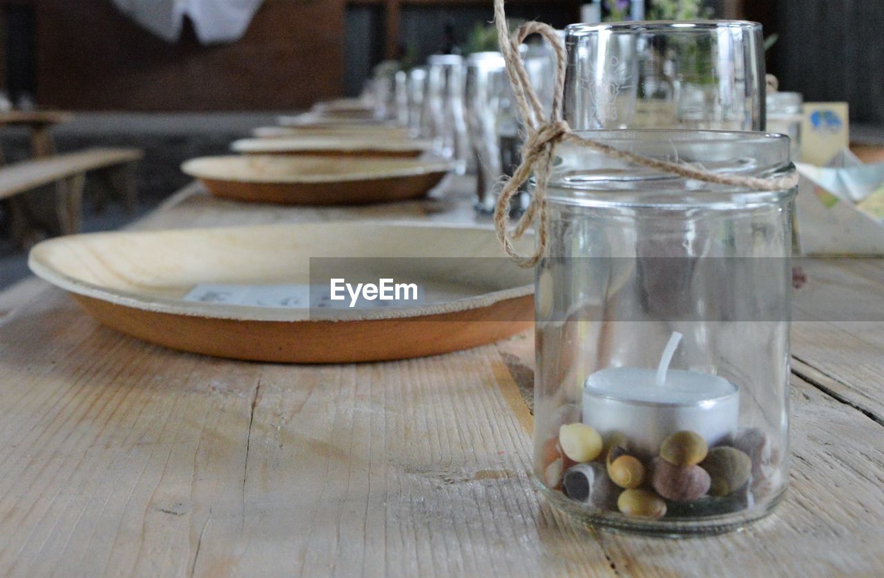 Close-up of place settings and jar on table