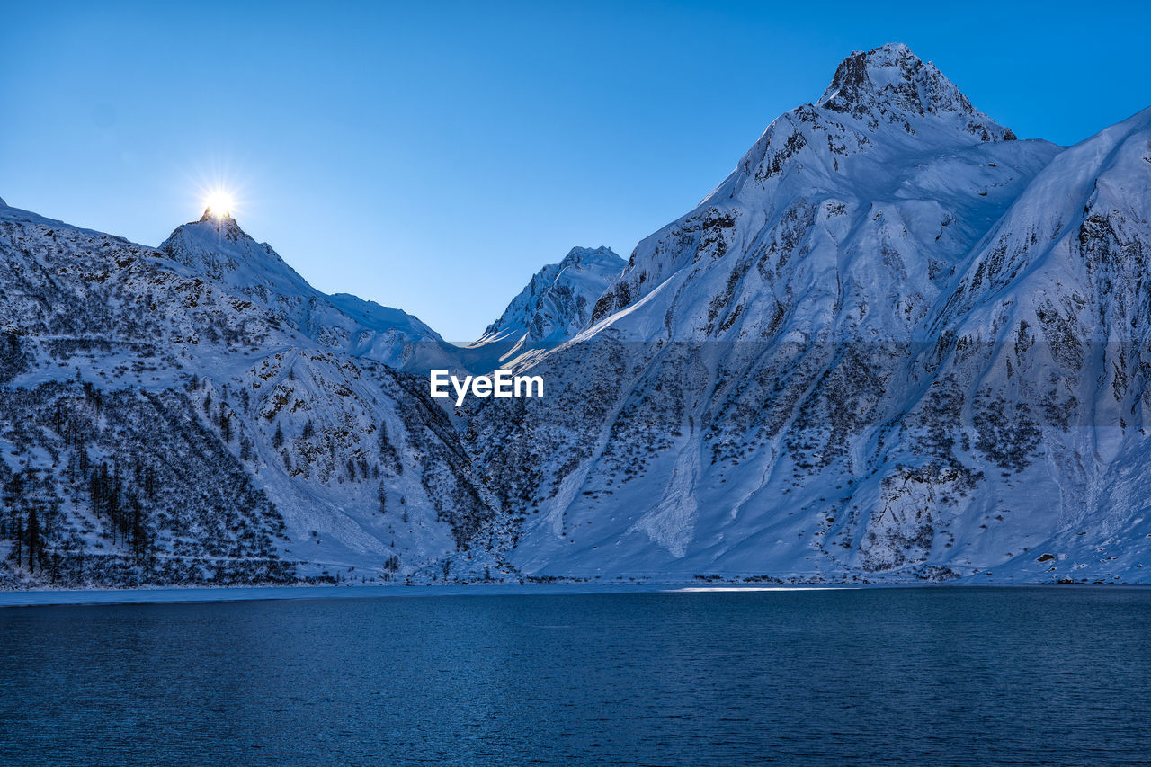 scenic view of snowcapped mountains against clear sky