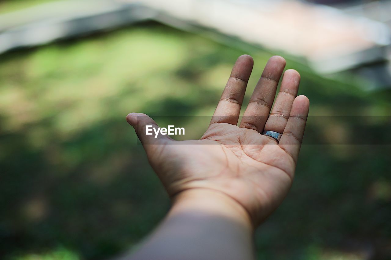 Close-up of hand gesturing outdoors