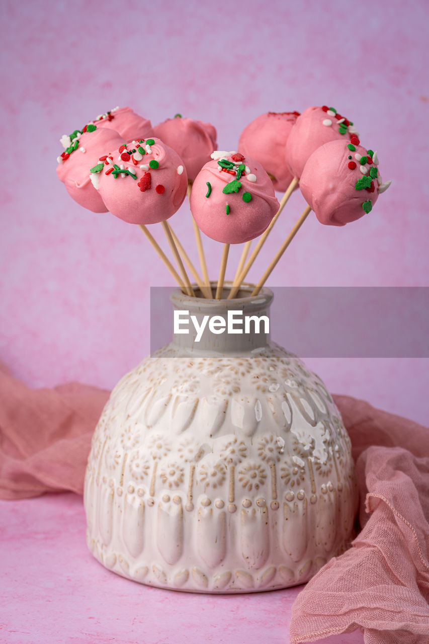 Homemade cake pops in a vase on the table