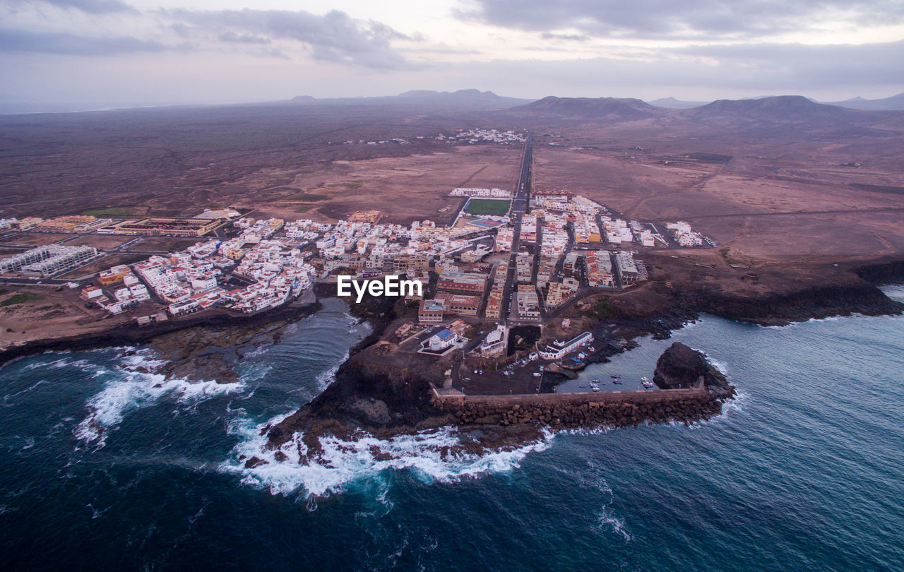 High angle view of bay against cloudy sky