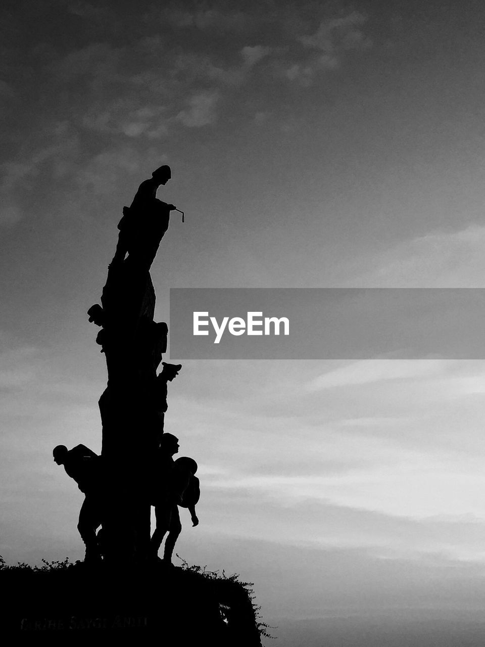 Low angle view of silhouette statue against sky