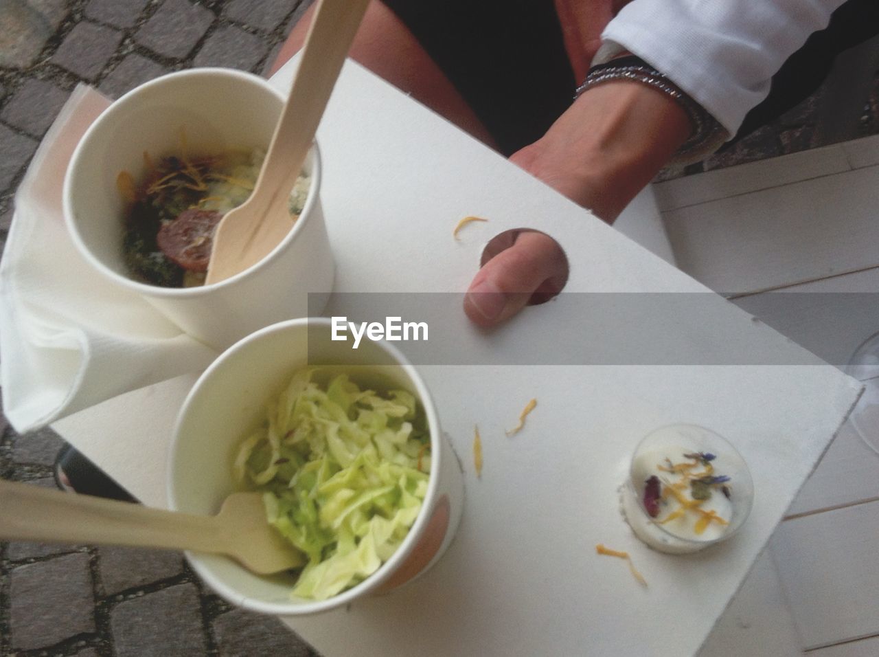 HIGH ANGLE VIEW OF HAND HOLDING BOWL OF FOOD
