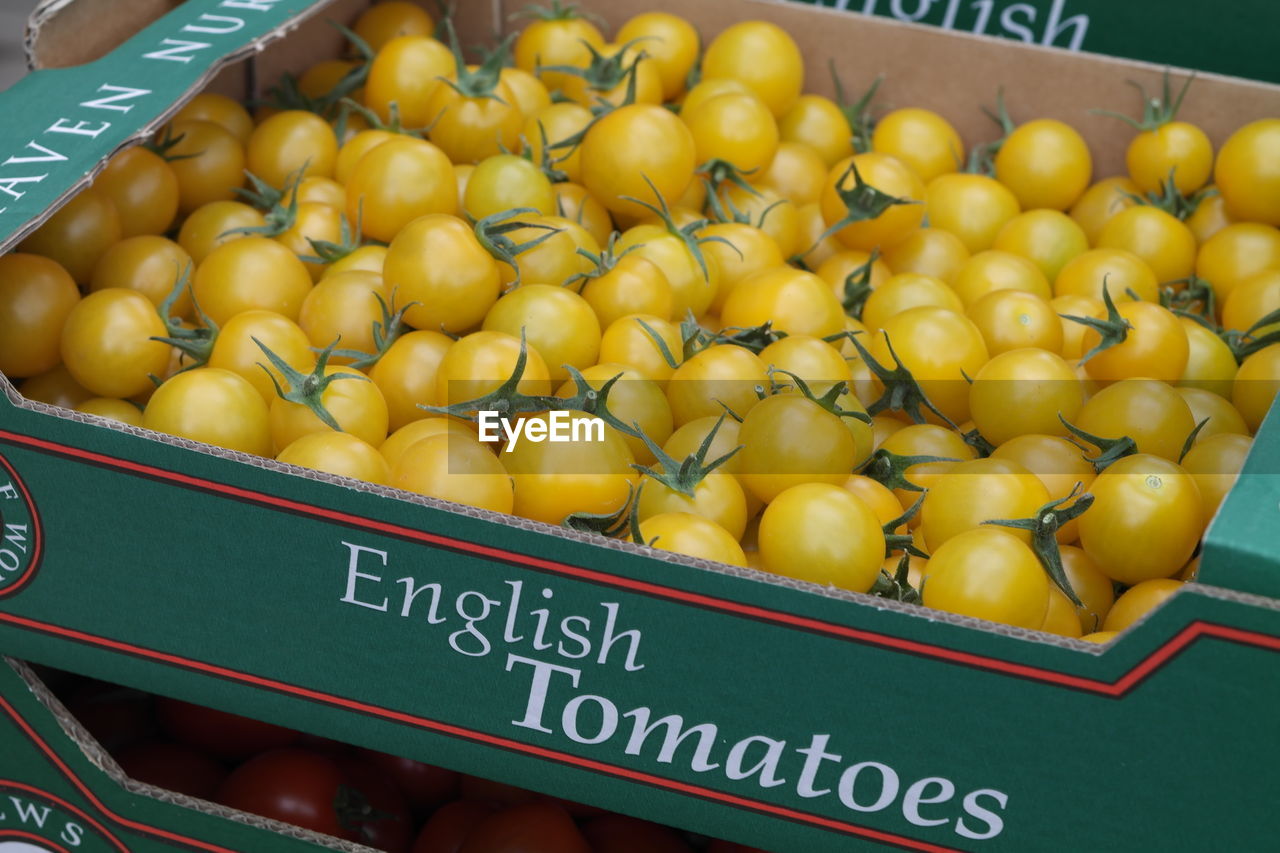 Yellow cherry tomatoes for sale at market stall