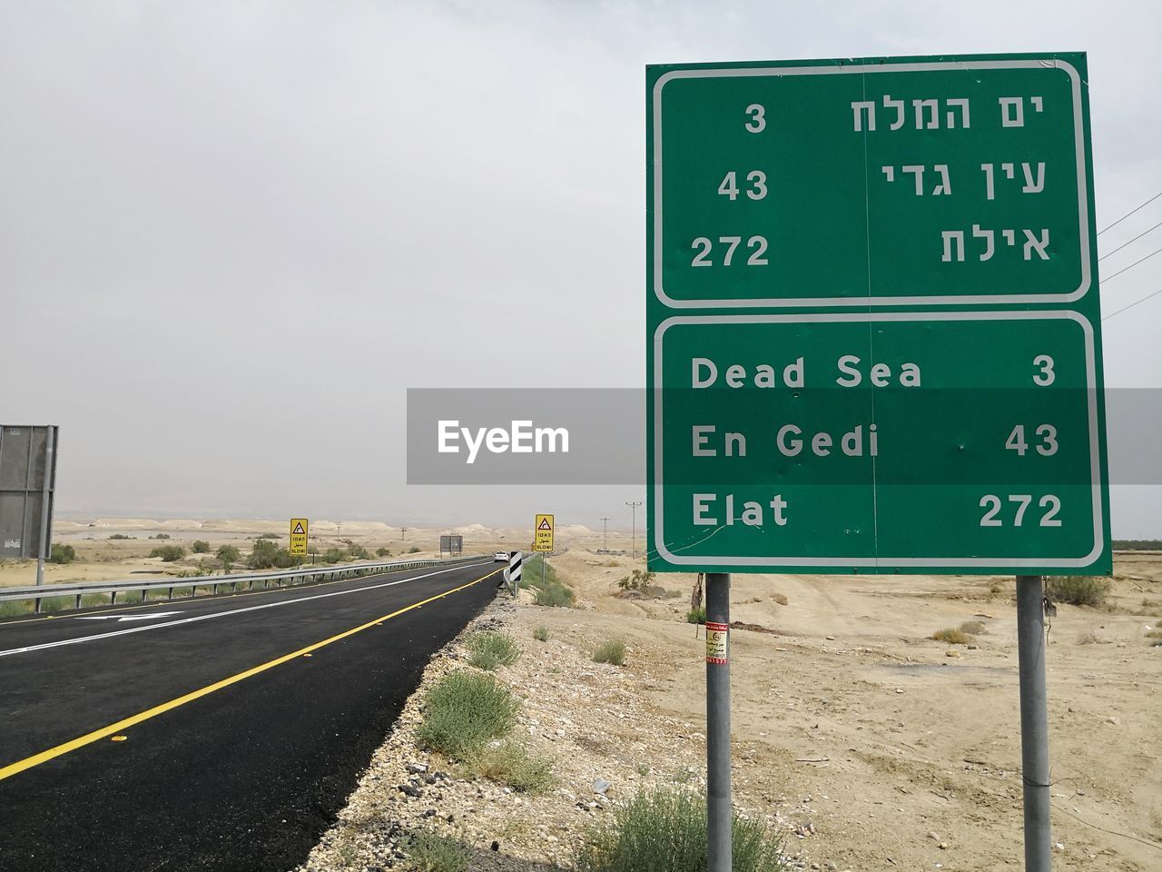 Road with road sign in the judean desert near the dead sea