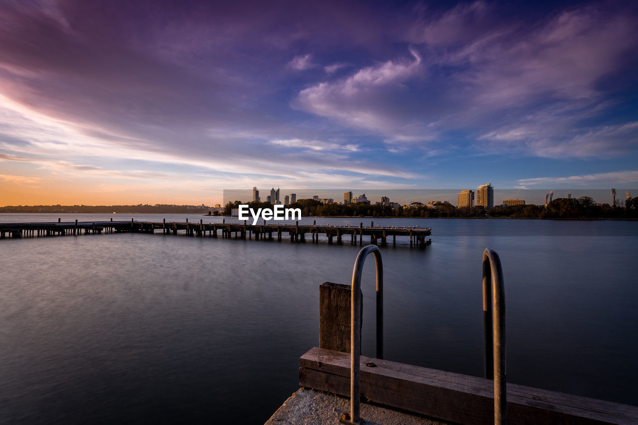 VIEW OF RIVER AND CITYSCAPE AGAINST SKY