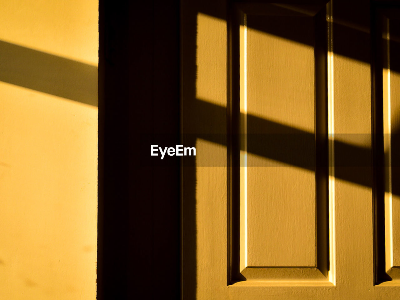 The sunset rays and shadows over the window 