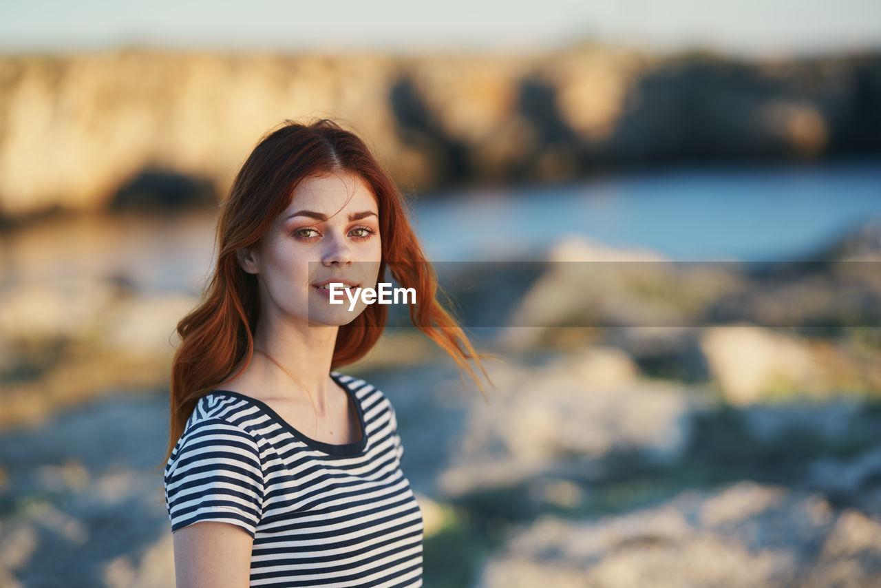 Portrait of smiling young woman standing outdoors