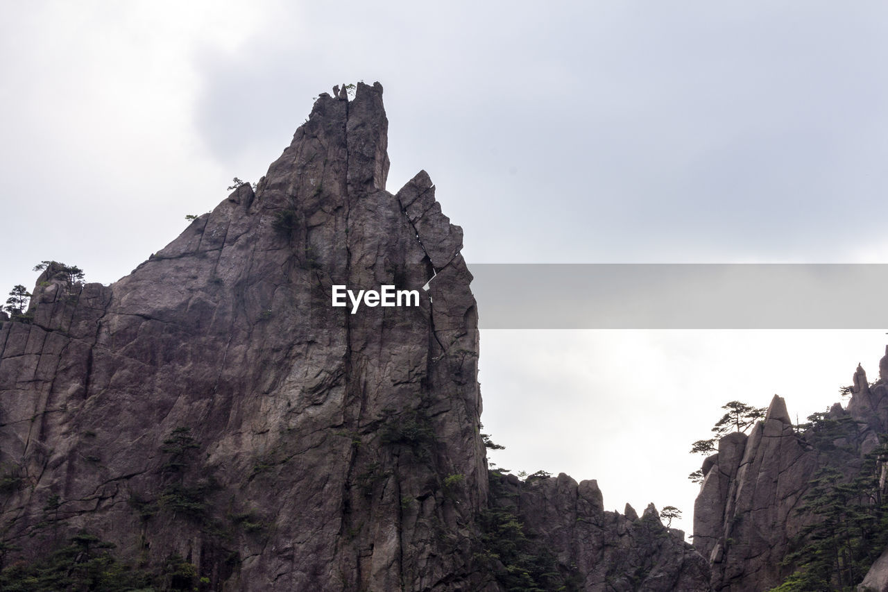 LOW ANGLE VIEW OF ROCK FORMATIONS AGAINST SKY