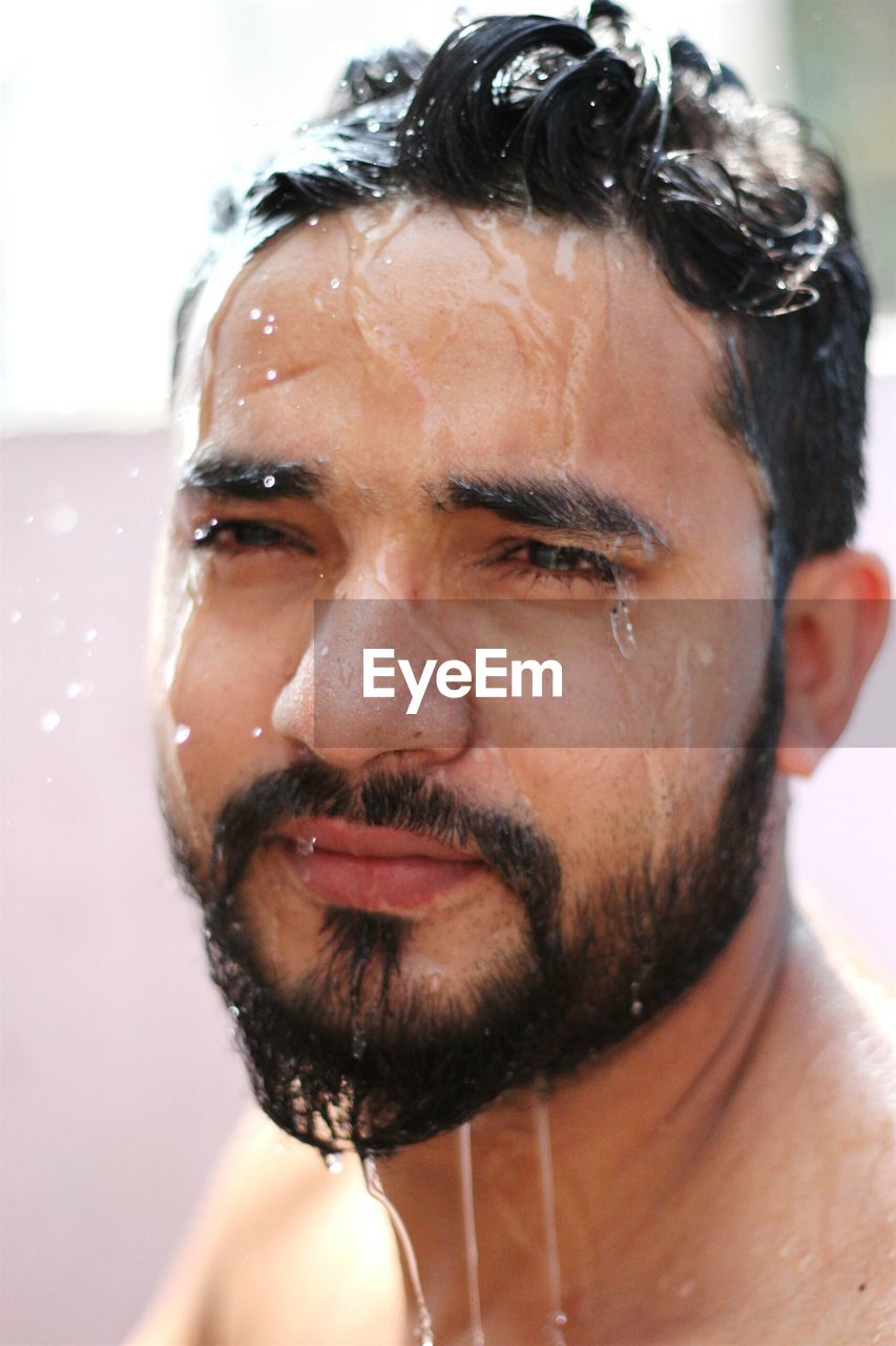 Close-up of wet bearded man