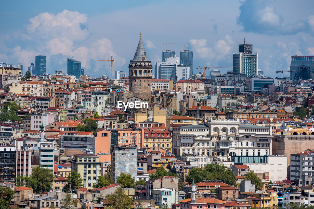 Cityscape against cloudy sky