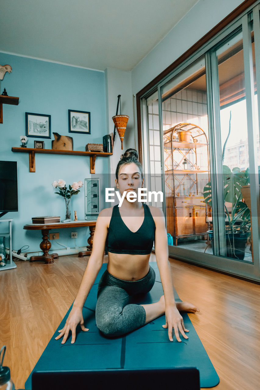 portrait of young woman exercising at home