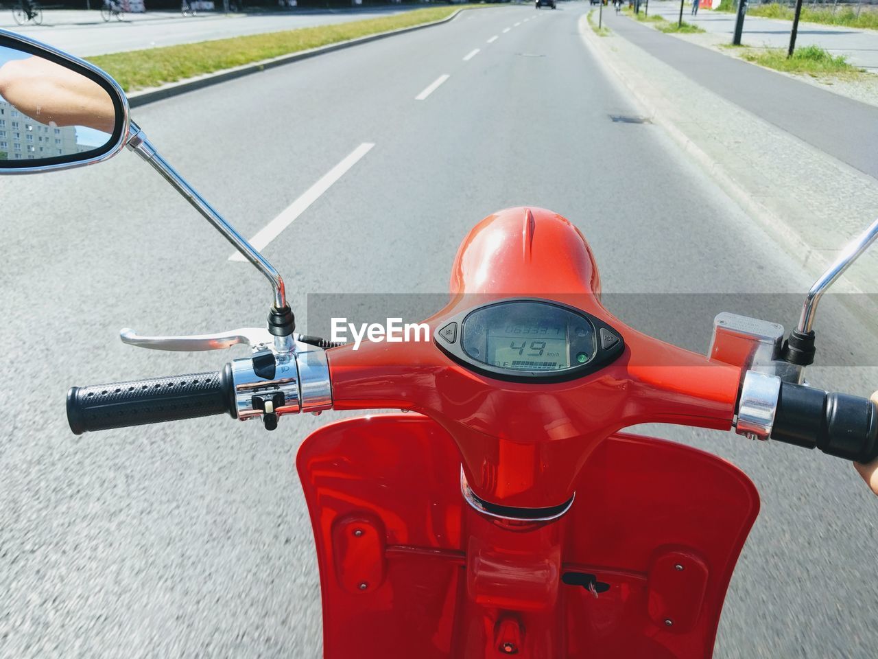 Close-up of red scooter on road