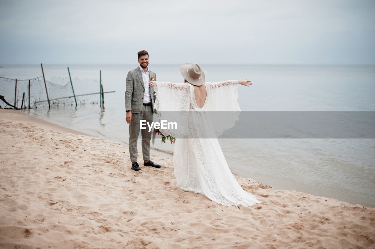Bride and bridegroom at beach during wedding ceremony