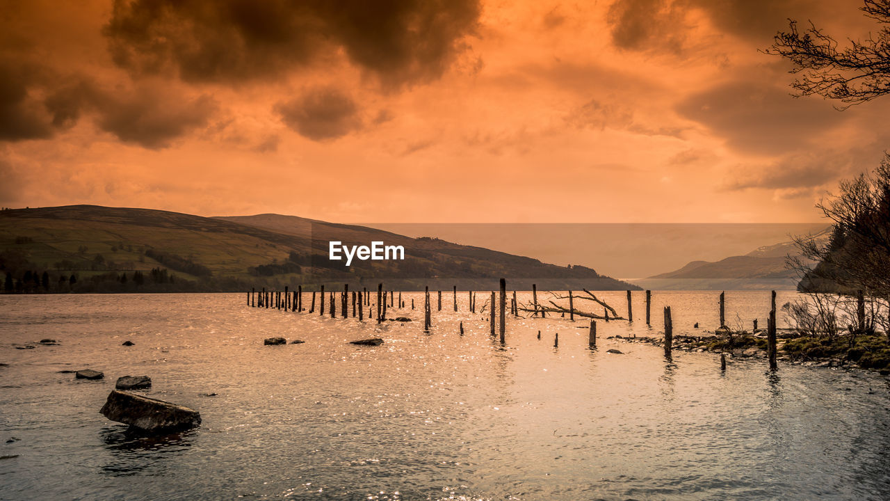 Scenic view of lake against sky during sunset