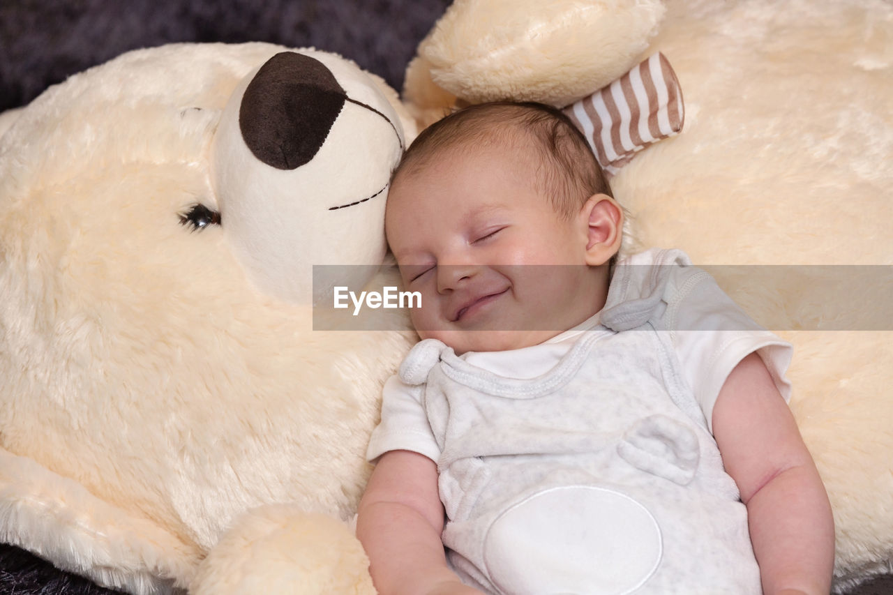 HIGH ANGLE VIEW OF BABY GIRL SLEEPING IN TOY