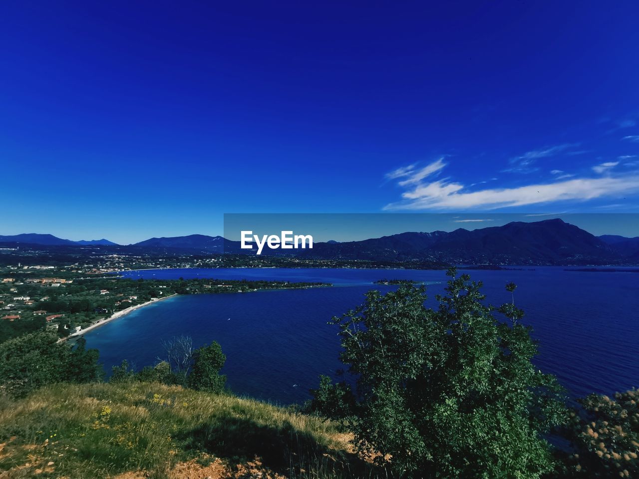 Scenic view of lake against blue sky