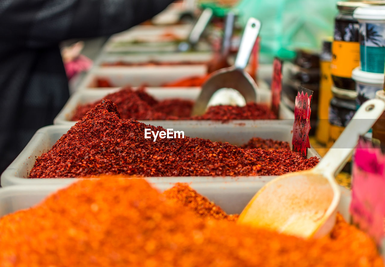 Close-up of spices in containers at market stall