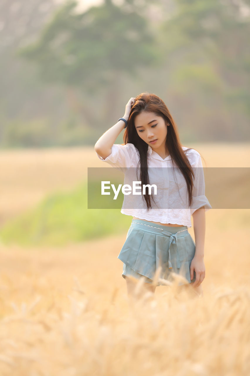 Young woman standing on field