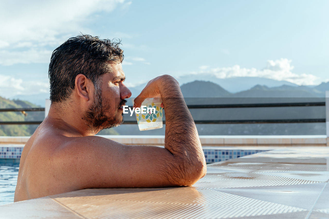 Man drinking in a pool