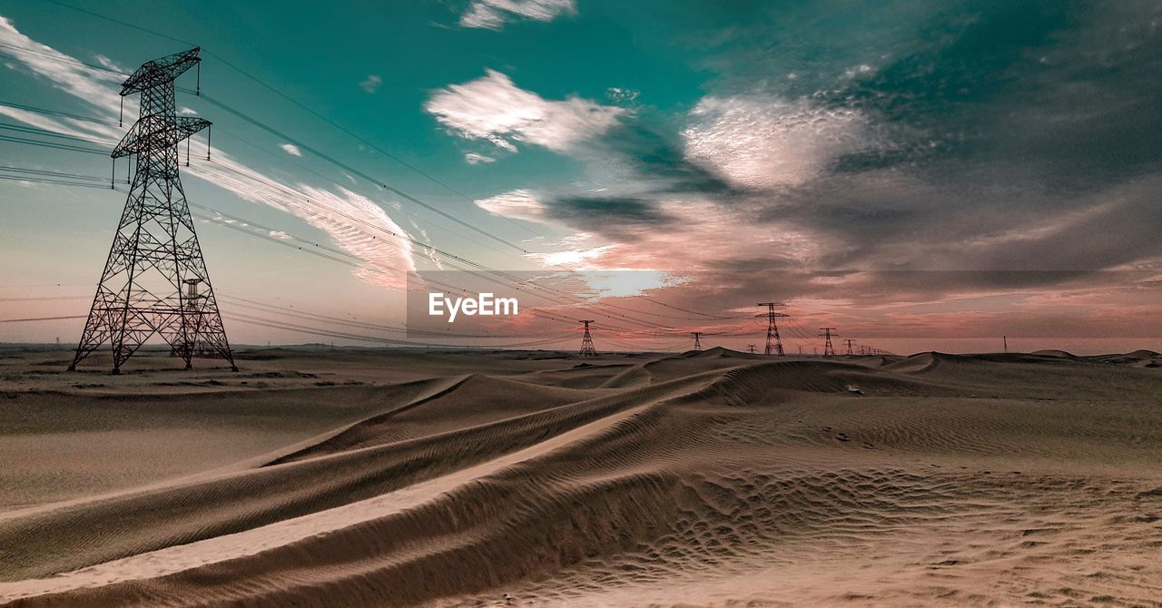 Rural desert scene against dramatic sunset sky